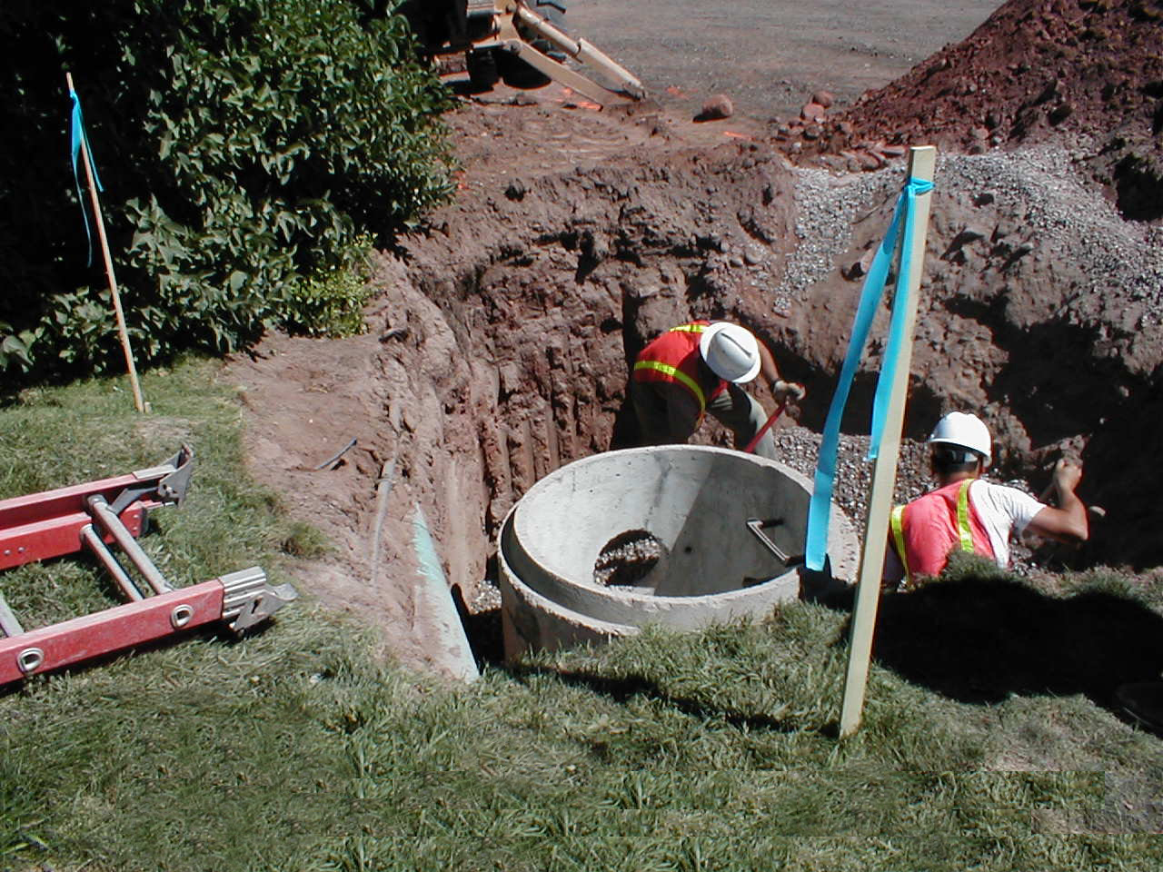Utility company reconstructing a manhole within an easement.